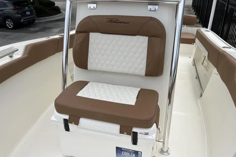 Slide: The Image of 2025 Pioneer 202 Sportfish boat interior with cushioned seating and integrated cooler. - 8