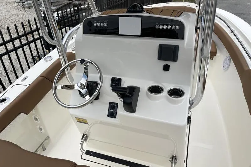 Slide: The Image of 2025 Pioneer 202 Sportfish boat console with steering wheel and controls. - 9