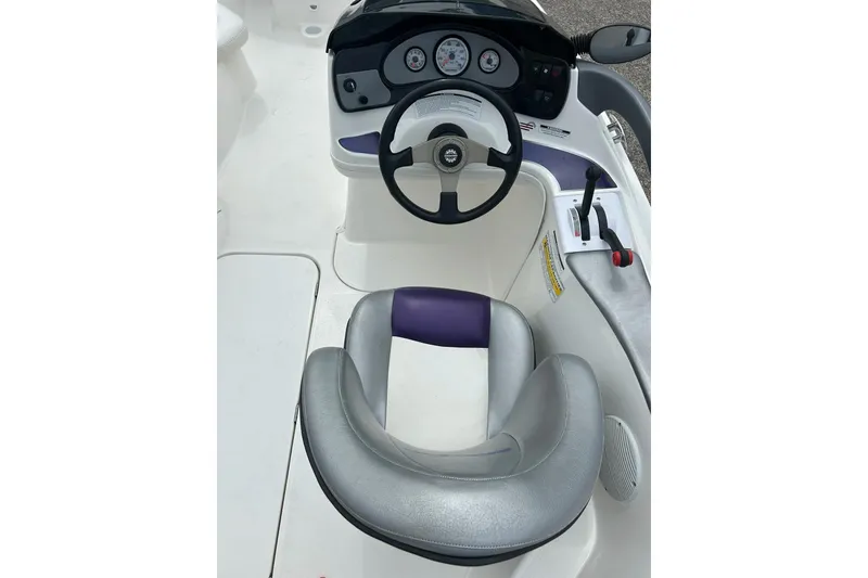 Slide: The Image of 2003 Sea Doo 2000 boat interior with gray and purple seating. - 10