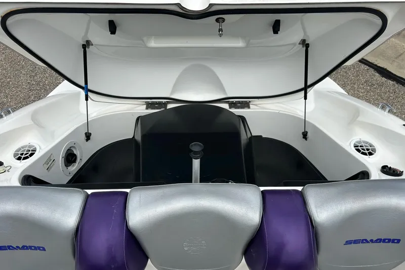 Slide: The Image of Open storage compartment of a 2003 Sea Doo 2000 watercraft, showing interior details. - 16