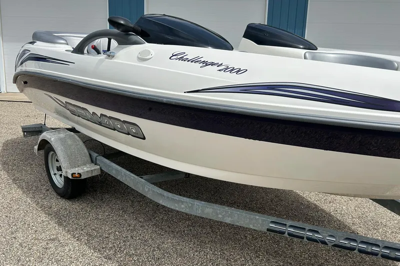 Slide: The Image of Sea Doo Challenger 2000 boat on trailer, 2003 model, white with blue accents. - 22