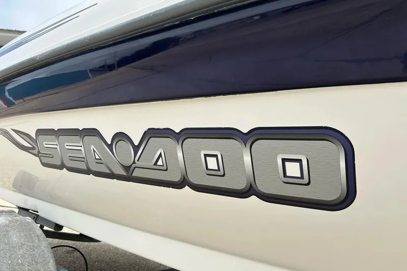 Slide: The Image of Close-up of 2003 Sea Doo 2000 model logo on boat exterior. - 23