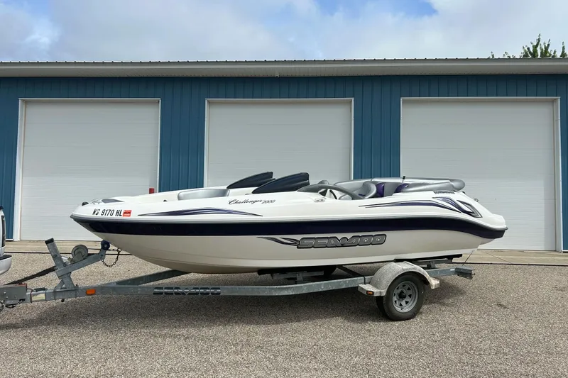 Slide: The Image of 2003 Sea Doo Challenger 2000 boat on trailer, parked in front of blue garage. - 27