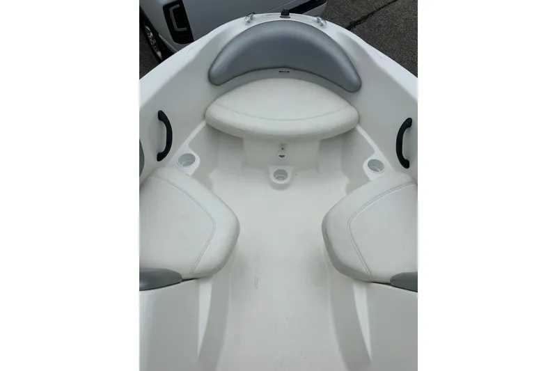 Slide: The Image of Interior seating of a 2003 Sea Doo 2000 boat, featuring white and gray cushions. - 7