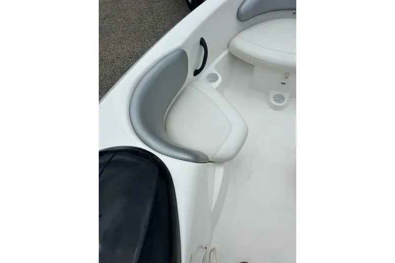 Slide: The Image of Interior seating of a 2003 Sea Doo 2000 boat, featuring white cushioned seats. - 8