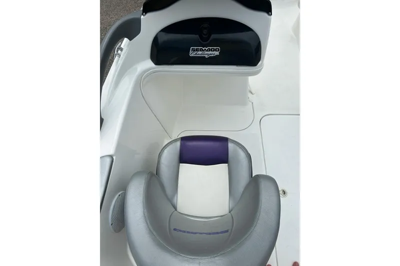Slide: The Image of Interior of a 2003 Sea Doo 2000 boat with white seating and gray accents. - 9