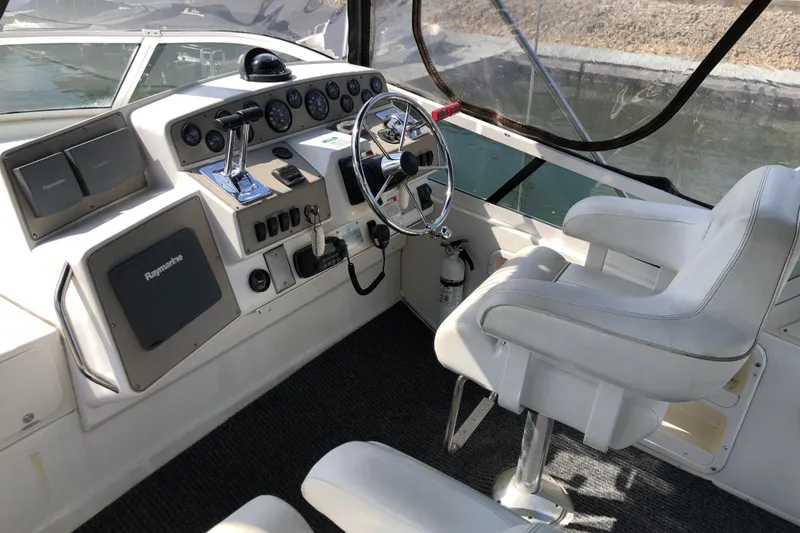 Slide: The Image of Helm of 2001 Carver 374 Voyager with steering wheel, controls, and navigation equipment. - 12