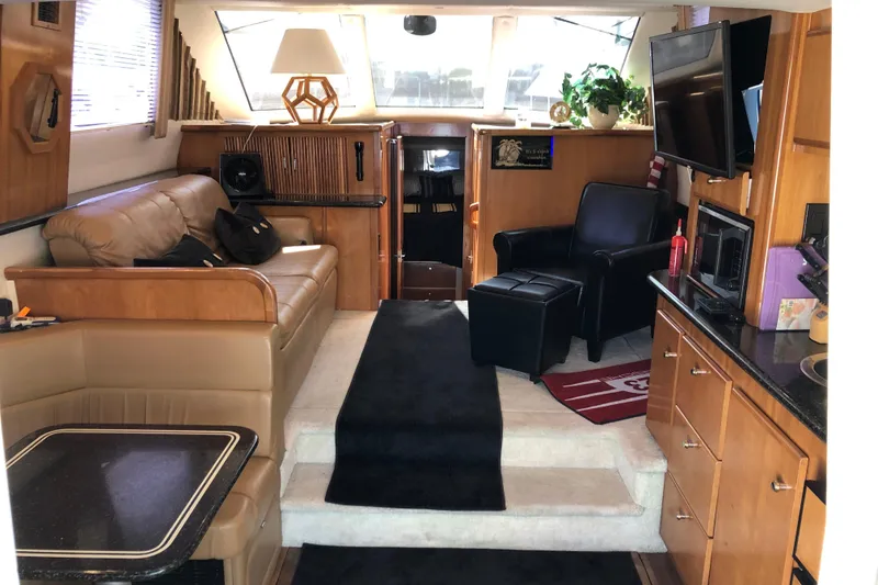 Slide: The Image of Luxurious interior of a 2001 Carver 374 Voyager yacht with leather seating and modern amenities. - 15