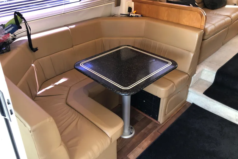 Slide: The Image of 2001 Carver 374 Voyager interior with tan leather seating and black table. - 16