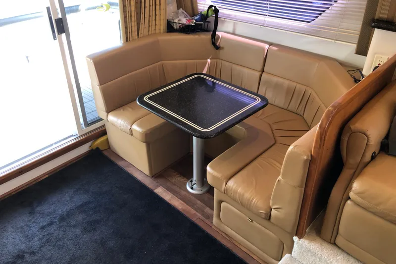 Slide: The Image of 2001 Carver 374 Voyager interior with beige leather seating and black table. - 19