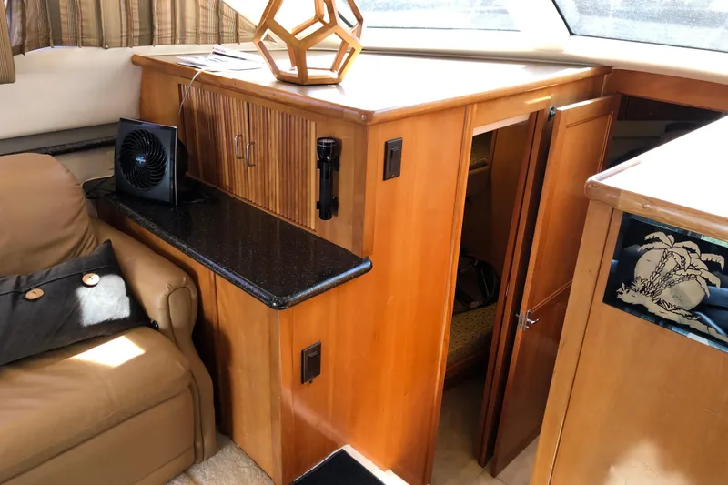 Slide: The Image of Interior of 2001 Carver 374 Voyager yacht with wooden cabinetry and seating area. - 21