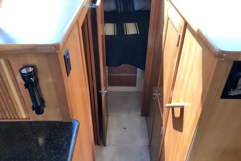 Slide: The Image of Interior view of 2001 Carver 374 Voyager yacht with wooden cabinetry and hallway. - 22