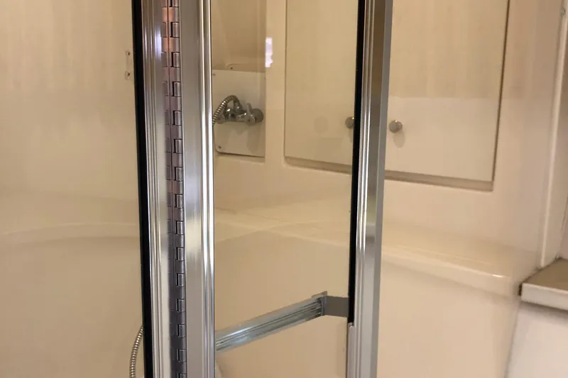 Slide: The Image of Shower area inside 2001 Carver 374 Voyager yacht, featuring glass door and chrome fixtures. - 26