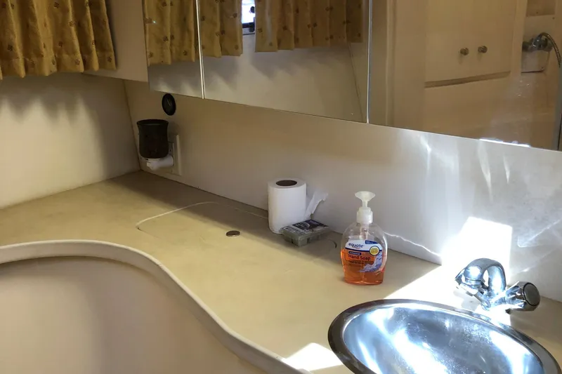 Slide: The Image of Bathroom sink area in a 2001 Carver 374 Voyager yacht, featuring soap and toiletries. - 27