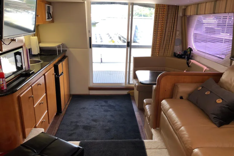 Slide: The Image of Interior of 2001 Carver 374 Voyager yacht with cozy seating and kitchenette. - 28