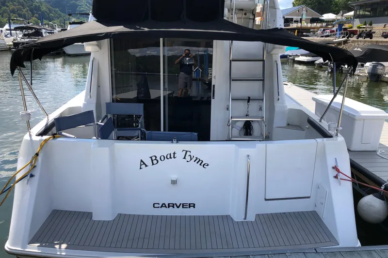Slide: The Image of 2001 Carver 374 Voyager yacht docked, featuring "A Boat Tyme" on the stern. - 4
