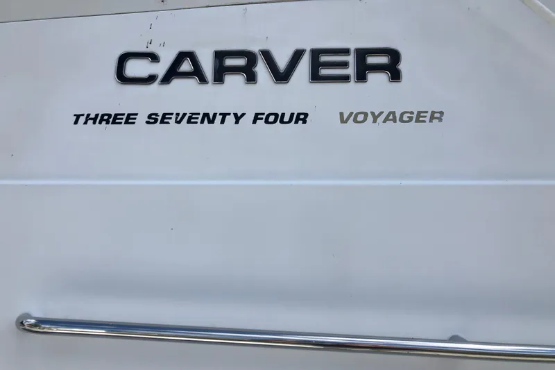 Slide: The Image of 2001 Carver 374 Voyager boat nameplate with chrome railing detail. - 7