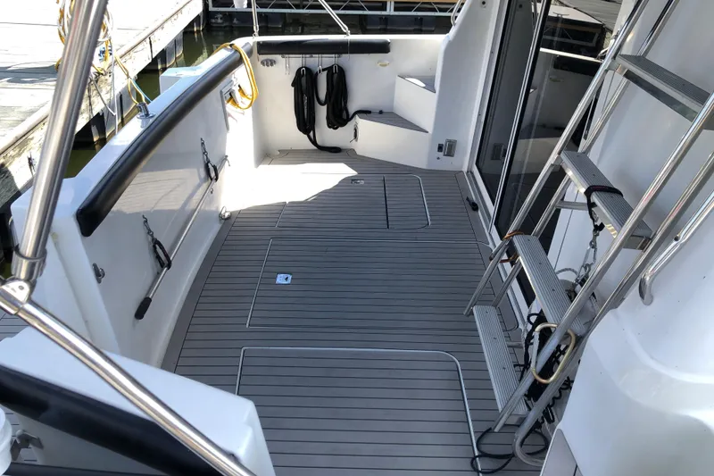 Slide: The Image of 2001 Carver 374 Voyager yacht deck with ladder and dock view. - 8