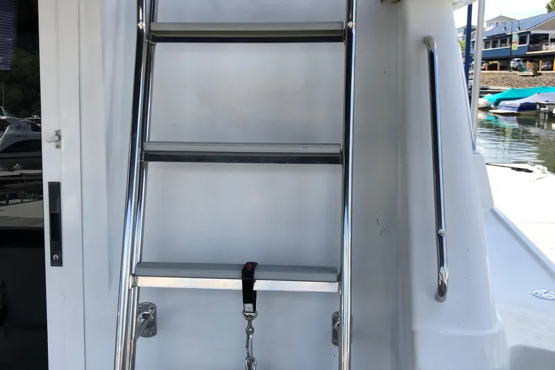 Slide: The Image of Ladder on 2001 Carver 374 Voyager yacht, docked near waterfront. - 9