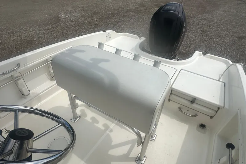 Slide: The Image of Interior view of a 2022 Trophy T-18 boat, featuring steering wheel and seating. - 16