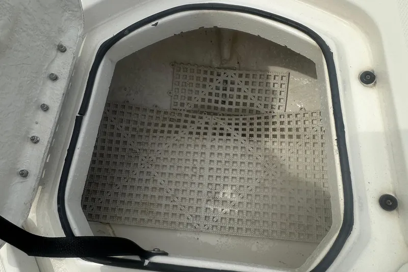 Slide: The Image of Open storage compartment in 2022 Trophy T-18 boat with grid flooring. - 19