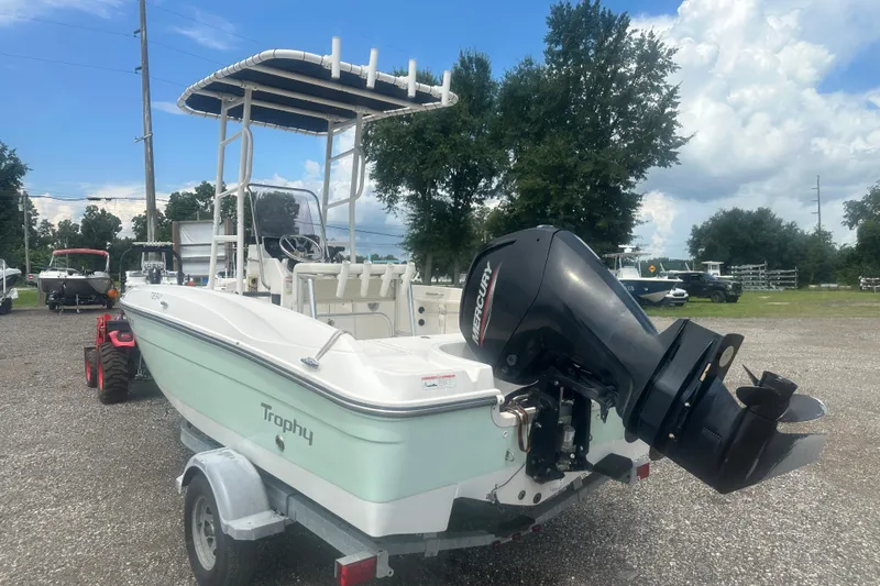 Slide: The Image of 2022 Trophy T-18 boat with Mercury outboard motor on trailer, parked outdoors. - 4