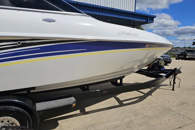 Slide: The Image of 2005 Baja 275 boat on trailer, featuring sleek design and vibrant blue-yellow accents. - 10