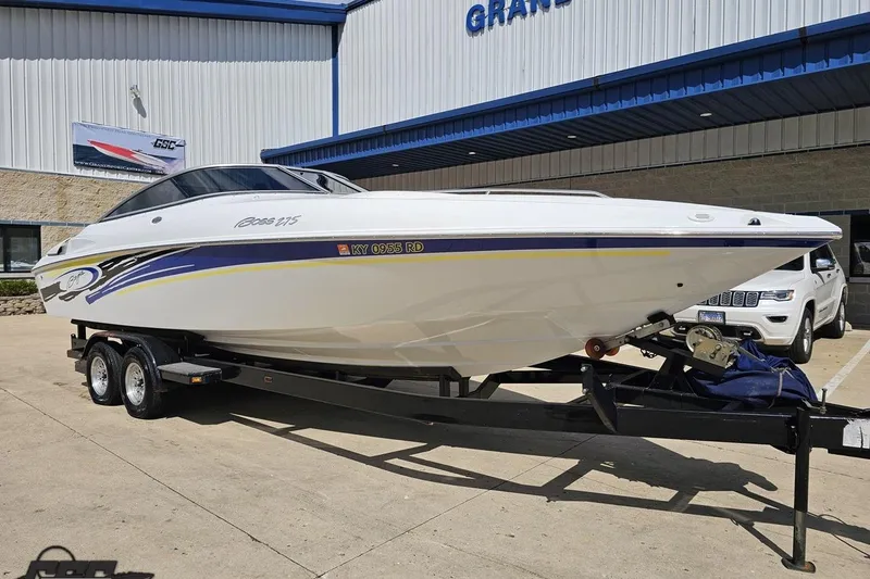 Slide: The Image of 2005 Baja 275 boat on trailer outside dealership, featuring sleek design and vibrant graphics. - 11