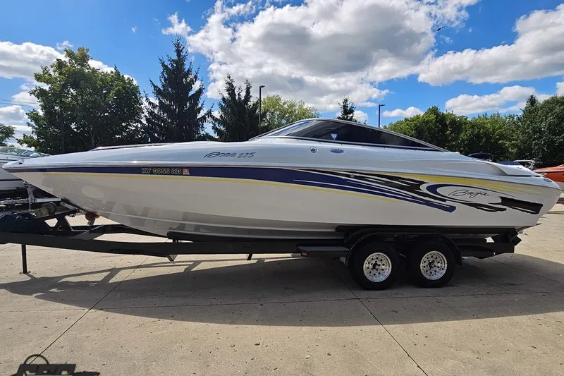 Slide: The Image of 2005 Baja 275 boat on trailer, sleek design, vibrant graphics, parked outdoors. - 17