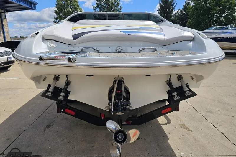 Slide: The Image of Rear view of a 2005 Baja 275 boat on a trailer, showcasing the propeller and stern. - 28
