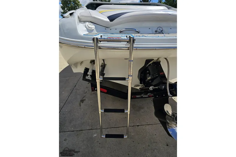 Slide: The Image of 2005 Baja 275 boat with extended swim ladder and visible outboard motor. - 31