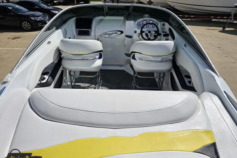 Slide: The Image of 2005 Baja 275 boat interior with white seating and dashboard controls. - 35