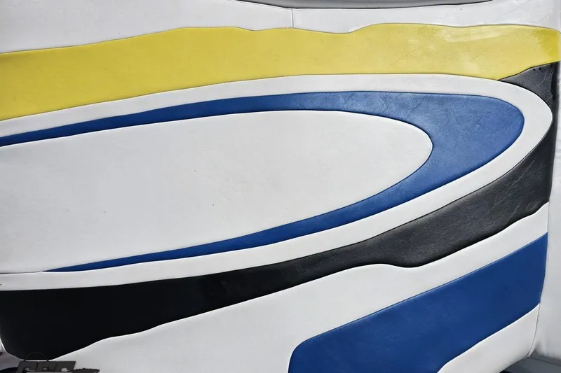 Slide: The Image of Colorful seat design in a 2005 Baja 275 boat, featuring yellow, blue, and black curves. - 39