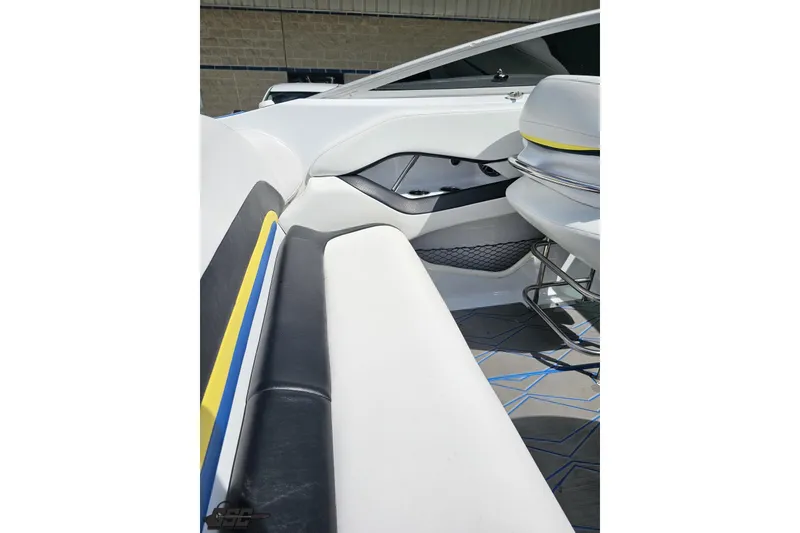 Slide: The Image of Interior of a 2005 Baja 275 boat with white and black seating. - 52