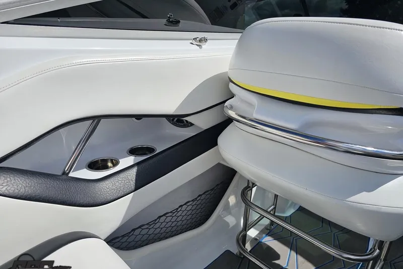 Slide: The Image of 2005 Baja 275 boat interior with white seating and cup holders. - 53