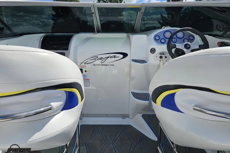 Slide: The Image of Interior of a 2005 Baja 275 boat with sleek white and blue design. - 55