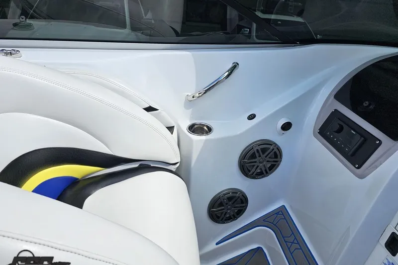 Slide: The Image of Interior of a 2005 Baja 275 boat featuring white seating and audio speakers. - 61