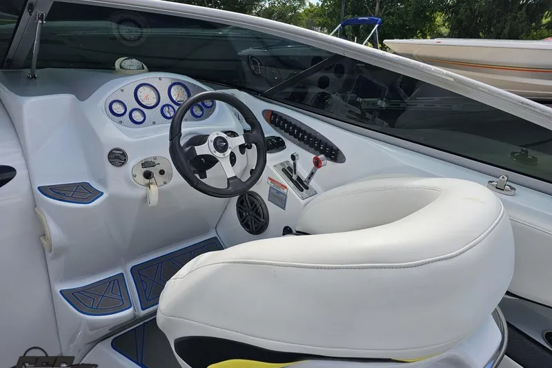 Slide: The Image of 2005 Baja 275 boat interior with white seating and control dashboard. - 63