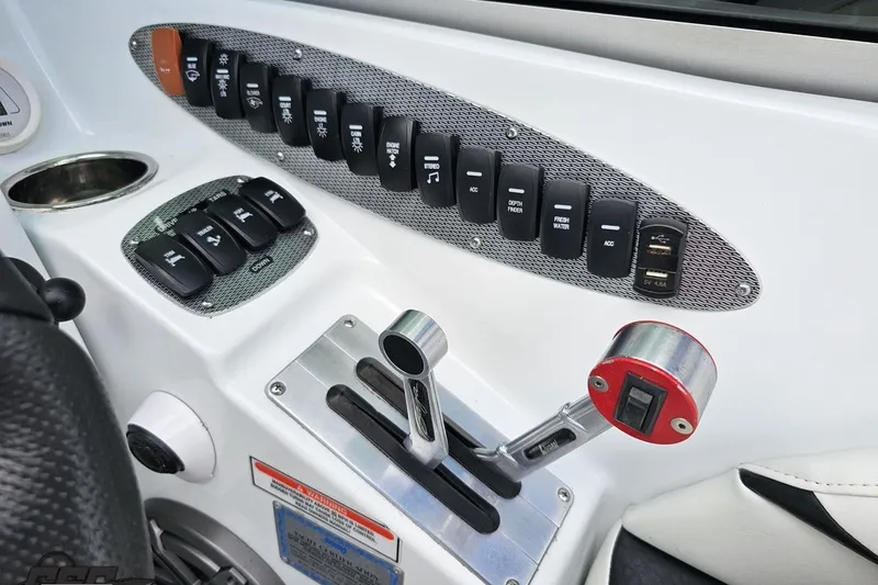Slide: The Image of Control panel of a 2005 Baja 275 boat with switches and throttle lever. - 68