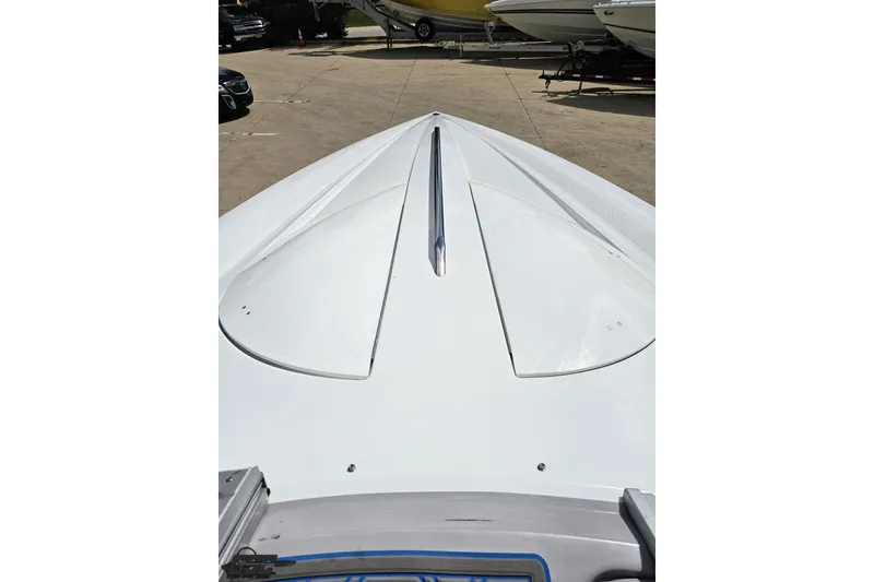 Slide: The Image of 2005 Baja 275 boat deck, sleek white design, parked outdoors. - 71