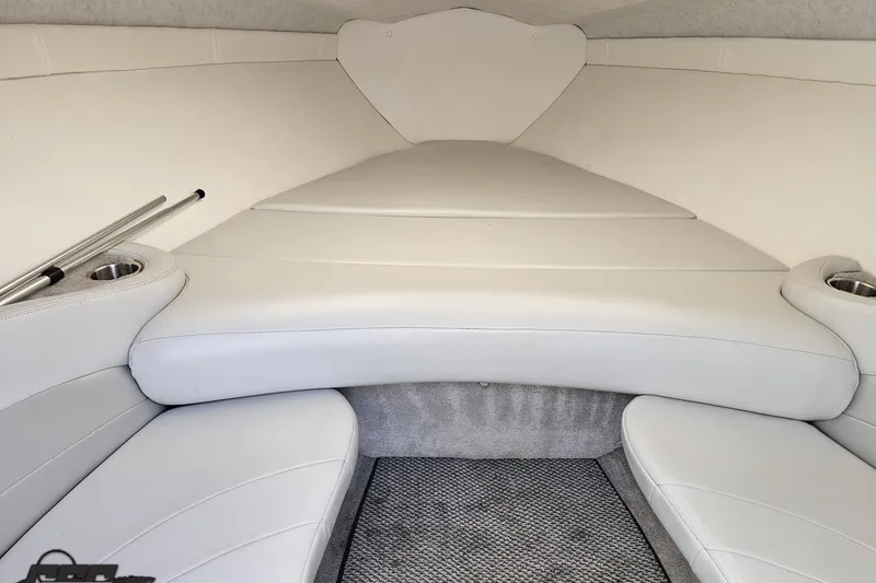 Slide: The Image of 2005 Baja 275 boat interior with white cushioned seating and carpeted flooring. - 73