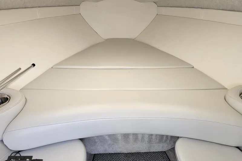 Slide: The Image of Interior of a 2005 Baja 275 boat with white cushioned seating. - 74
