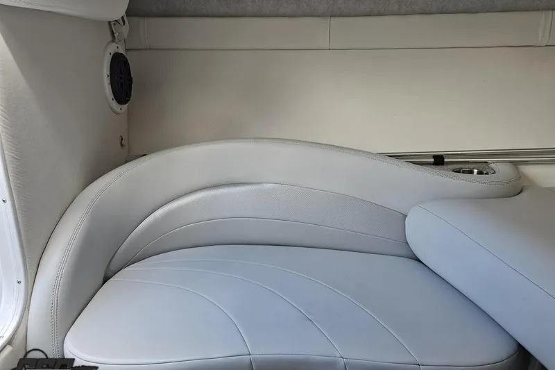 Slide: The Image of 2005 Baja 275 boat interior with white leather seating and speaker. - 77