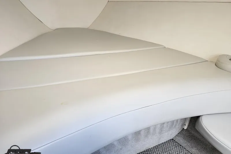 Slide: The Image of Interior view of a 2005 Baja 275 boat cabin with white upholstery. - 79