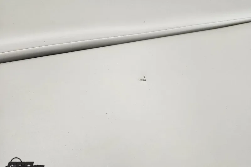 Slide: The Image of Small tear on white upholstery of 2005 Baja 275 boat. - 80