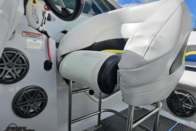 Slide: The Image of Interior of a 2005 Baja 275 boat featuring white seating and JL Audio speakers. - 86
