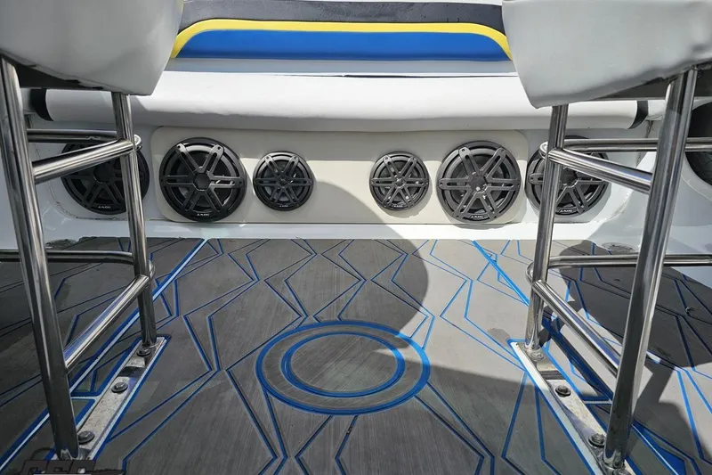 Slide: The Image of 2005 Baja 275 boat interior with custom flooring and multiple audio speakers. - 89