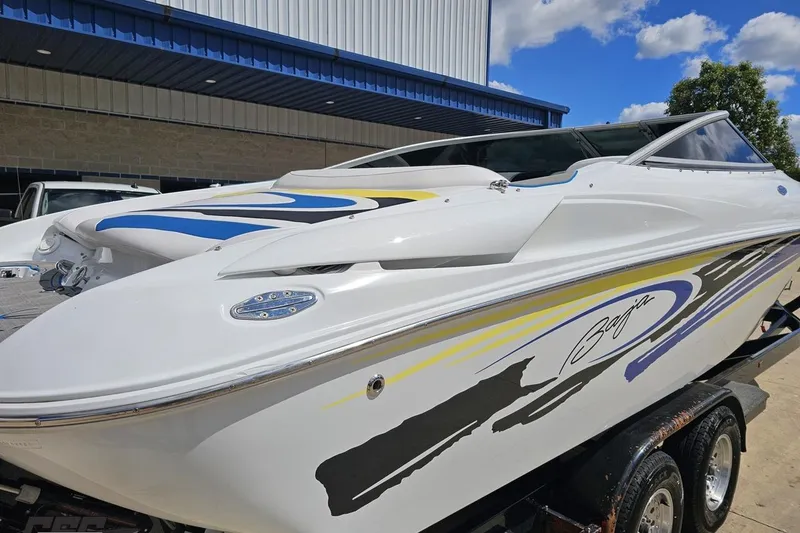Slide: The Image of 2005 Baja 275 speedboat with sleek design and vibrant graphics, parked outdoors. - 9