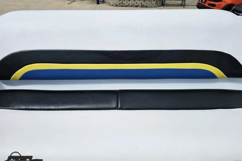 Slide: The Image of 2005 Baja 275 boat seat with black, blue, and yellow upholstery design. - 91