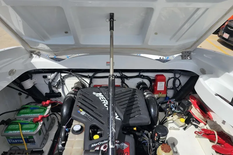 Slide: The Image of Open engine compartment of a 2005 Baja 275 boat, featuring a MerCruiser engine. - 97